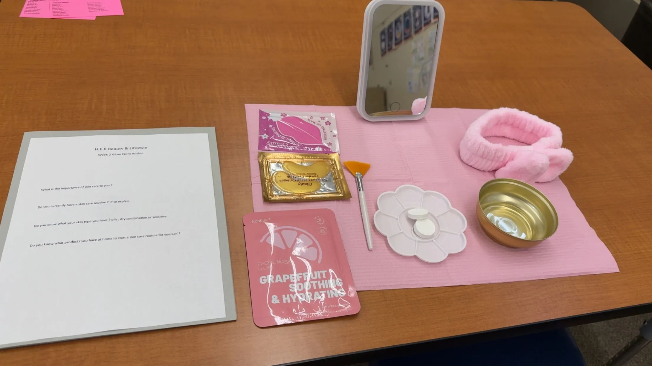 A skincare station with face masks, a mirror and the Glow From Within worksheet