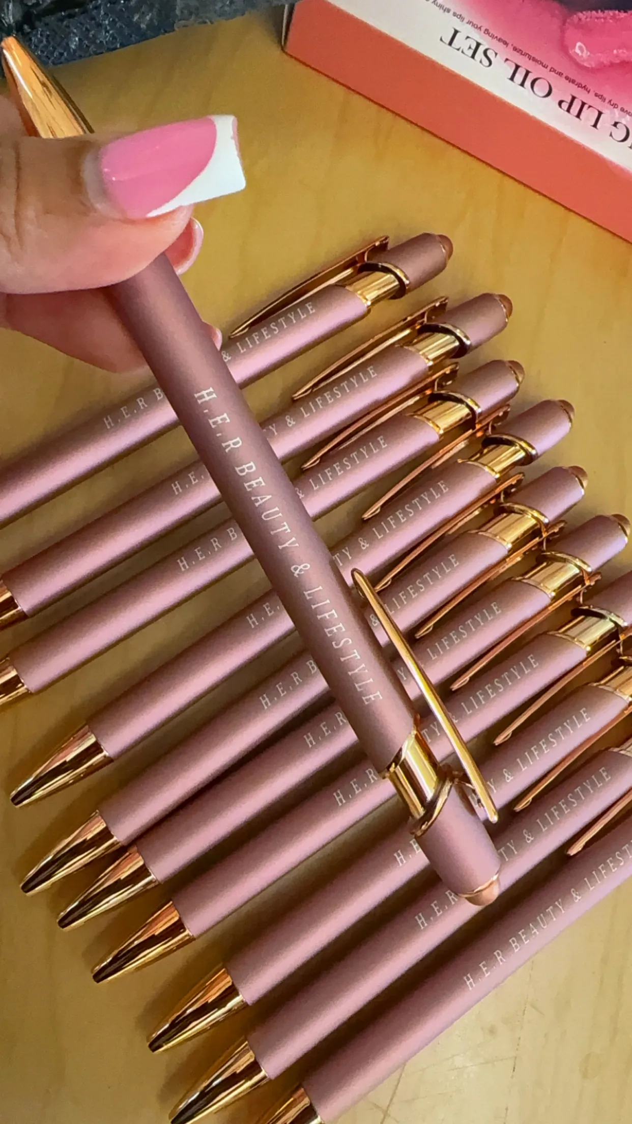 Rose gold pens printed with H.E.R Beauty and Lifestyle